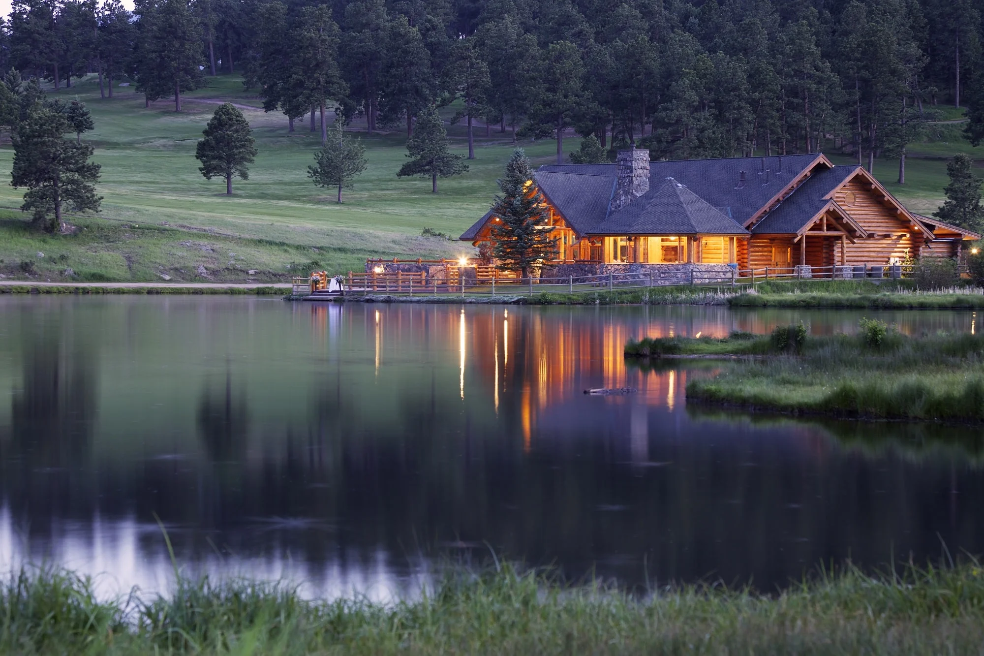 Mountain-Lodge-Reflecting-in-Lake-at-Dusk-165799923_5548x3698
