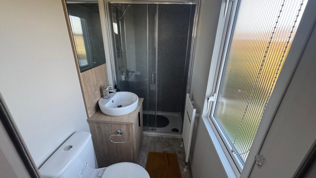 Open-plan living area: with TV and French doors leading to veranda Dining area Galley-style kitchen: with gas cooker, microwave, and fridge/freezer Bedroom 1: Double bed with ensuite sink and toilet Bedroom 2: Twin beds Shower Room: with shower cubicle and toilet.